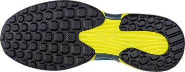 The image shows the sole of a sports shoe. It has a black, rubberized surface with a textured pattern and yellow, smooth areas. The shape is ergonomic and slightly curved.