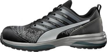 The shoe is sporty and dark, primarily in black with gray and silver accents. It features a cushioned sole and a breathable, textured upper.