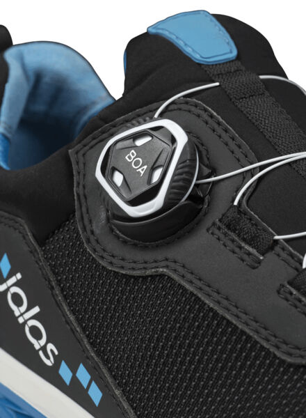 The image shows a black shoe with blue accents. On the shoe, there is a quick-lacing system with a round twist lock that securely tightens the laces.