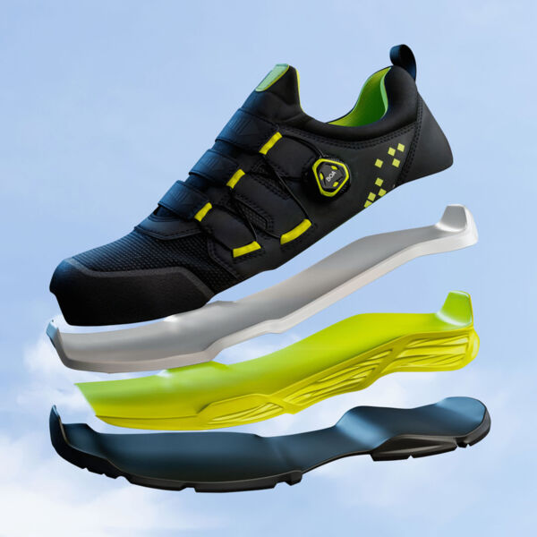 The image shows a modern, black sports shoe with green accents. The shoe is disassembled into individual parts: the sole is multi-layered, with a gray, a yellow, and a black layer.