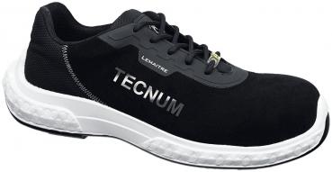 The shoe is a black sneaker made from breathable material with a white sole. The word "TECNUM" is written on the side. It has a snug fit with lacing.