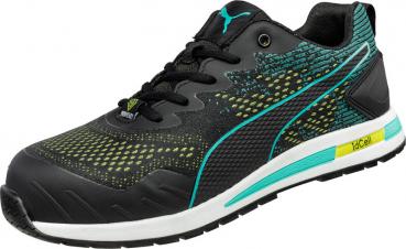 The shoe is black with a striking, textured pattern in yellow and turquoise. It has a low cut, laces, and a sturdy sole, ideal for athletic activities.