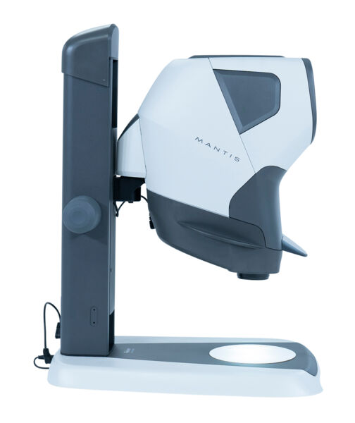 The image shows a compact, usually light gray device with rounded shapes. It features a camera view, a stable base, and controls on the side. Ideal for enlarging texts.