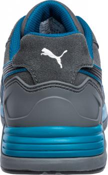 The image shows the back of a gray sports shoe with blue accents. The shoe features a padded surface and a clearly visible, white Puma brand. The sole is thick and textured.