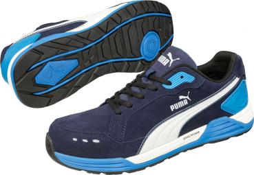 The image shows a pair of sports sneakers in navy blue with white and blue accents. The sole is black with blue rubber. The Puma logo is visible.