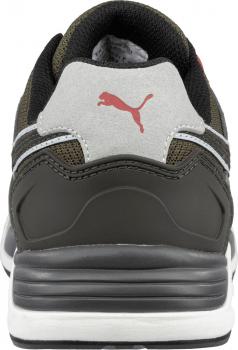 The image shows the rear view of a sports shoe. It is designed in a dark color with gray and white details. There is a red Puma logo on the heel.