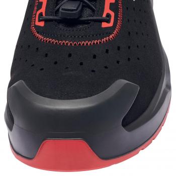 The image shows the front view of a black sports shoe with red accents. The shoe has a textured surface and a sturdy, grippy sole.