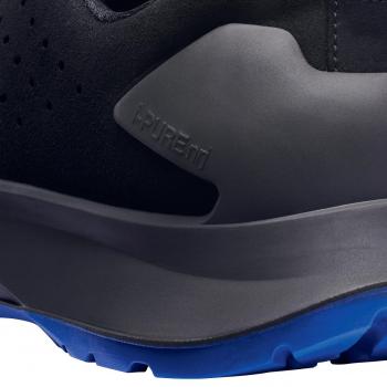 The image shows a black shoe with a blue sole. The sole has a textured tread, and there are raised dots and a matte surface. The shoe looks sporty and modern.