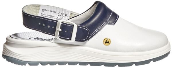 The image shows a white clog with a dark blue strap and a buckle. The sole is thick and provides good grip. A small yellow logo is also visible.