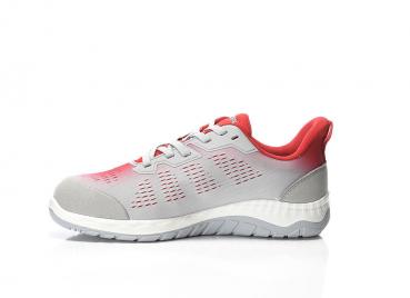 The shoe is a sporty sneaker in gray with red accents. It has a breathable surface, a padded heel, and a flexible, grippy sole.