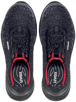 Here are two black athletic shoes with a smooth upper. They have a round toe cap, a comfortable shaft, and black laces with red accents.