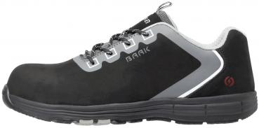 The shoe is a black safety shoe with a padded surface and gray accents. It has a sturdy sole and laces that provide good grip.