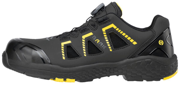 The shoe is low, black with yellow accents. It features a durable upper, side ventilation slits, and a reinforced toe cap. The sole is grippy and flexible.