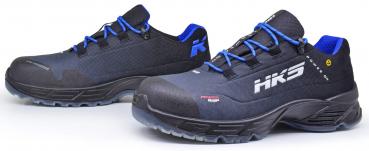 The image shows a pair of running shoes. They are black with blue shoelaces and have a grippy sole. On one side, there is the "HK3" logo. The shoes appear sporty and sturdy.