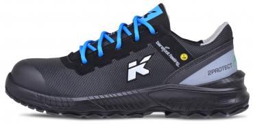 The shoe is black with blue shoelaces. The sole is robust and textured. A white logo print adorns it. The shoe has a reinforced toe cap for protection.