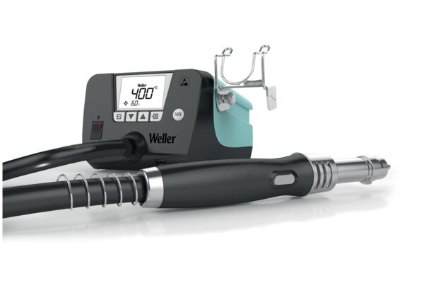 The image displays a soldering iron kit. It includes a digital control unit with a display and controls. Attached to a hose is the soldering tip.