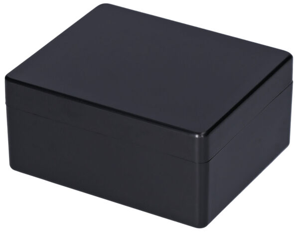 The image shows a rectangular, black box with a smooth lid. The edges are slightly rounded, and the surface appears glossy and uniform. The box is closed.