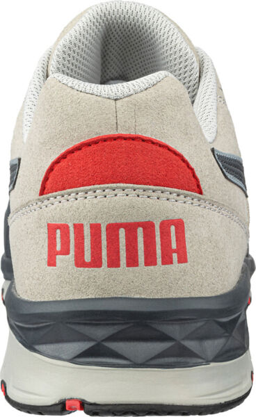 The shoe is a sporty sneaker in gray with a red accented area on the heel. The well-known logo "PUMA" is in large red letters on the back part.