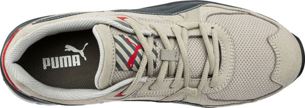 The image shows a gray sports shoe from Puma. It has a sturdy sole, wide laces, and a breathable surface. The Puma logo is clearly visible on the shoe.