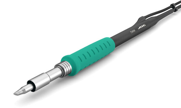 The image shows a soldering iron with a metallic tip and an ergonomic, green-rubberized handle. The handle has ridged structures for better grip. The cable connection is black.