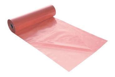 The image shows a roll of shiny, pink plastic material. Part of the material is laid flat on a surface, while the rest remains coiled on the roll.