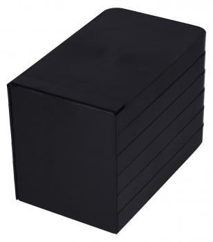 The image shows a rectangular, black box. It has a matte surface and is made up of several flat elements stacked on top of each other. The corners are rounded.