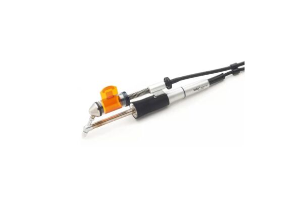 The image shows a tattoo device with a silver and black casing. It has an orange attachment and a long cable connection. The shape is slim and ergonomic.