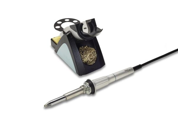 The image shows a soldering iron with a gray handle and a pointed soldering tip. Next to it is a soldering iron stand with a metal cleaning spiral and a sponge area.