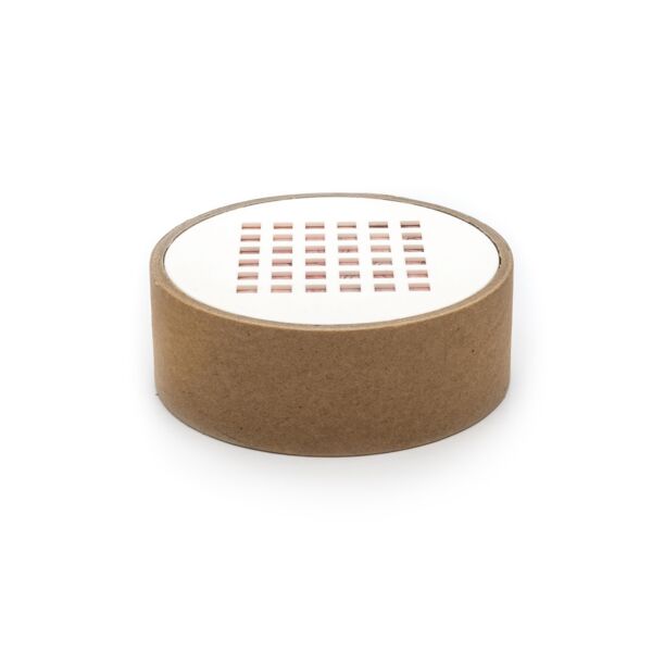 It is a round, flat container with a brown cardboard edge. The top surface is white and displays a pattern of small, colored dots in a grid-like design.