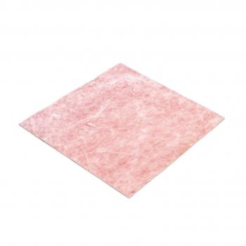 The image shows a square piece of material in soft pink. The surface is slightly textured and appears thin and somewhat transparent. It is lying flat on a surface.