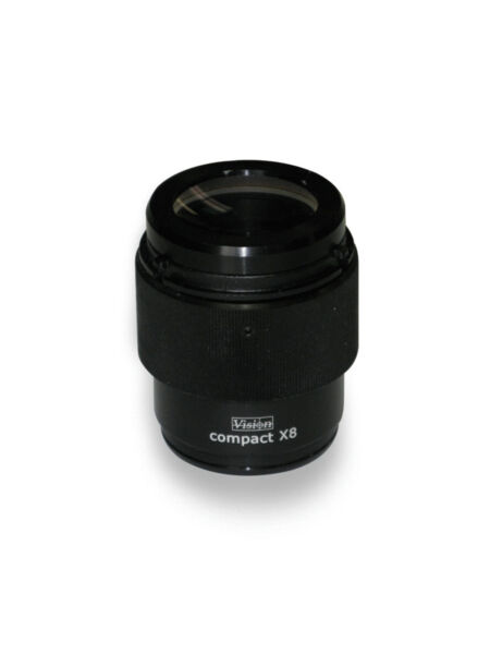 The image shows a black, cylindrical lens with a glass lens on top. It has a matte finish and features the inscription "compact X8" on the side. The overall shape is compact.