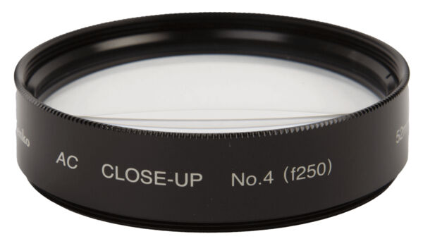 The image shows a black filter ring with a crystal-clear lens in the center. On the rim are white inscriptions 