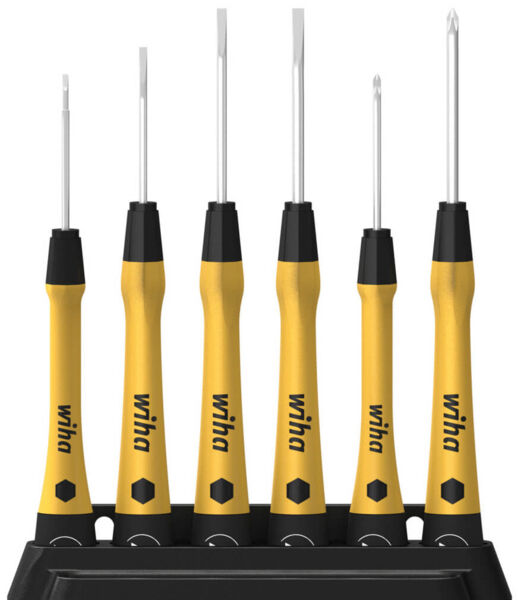 The image shows a set of six screwdrivers on a stand. The handles are yellow with a rubberized surface, and the tips are metallic shiny and of varying lengths.