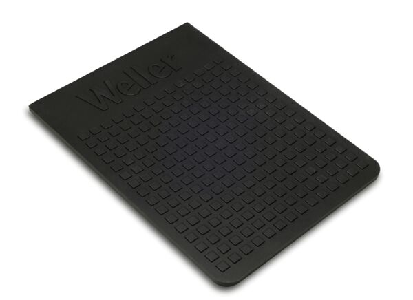 The image shows a rectangular, black mat with a grippy surface. It has a textured surface with small square bumps and bears the inscription "Weller".