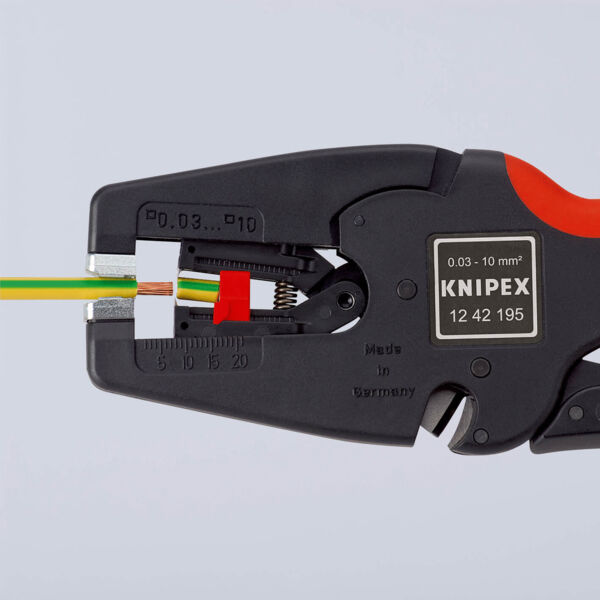 The image shows a wire cutter from Knipex. It is red and black and has an opening for wires of various sizes. Two colored wires (green and brown) are inserted.