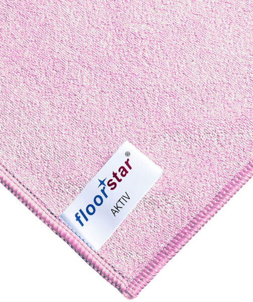 The image shows a pink microfiber cloth with a fine, soft texture. At the corner, there is a label that features the brand 