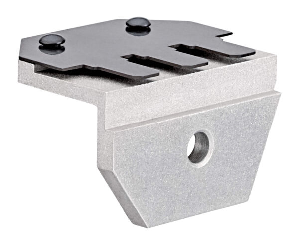 The image displays a metallic component in a square shape with a slanted bottom. At the top, two black screws are visible, embedded into a flat surface. There is a round hole on the side.