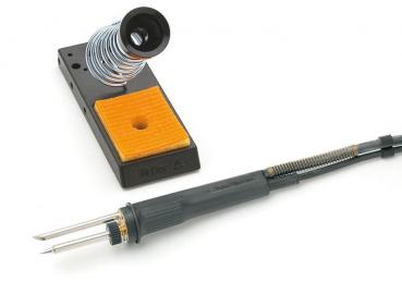 The image displays a soldering iron set. The iron features a black grip area with a thick end and two metal tips. Next to it is a soldering iron stand with a round spring and a yellow holder.