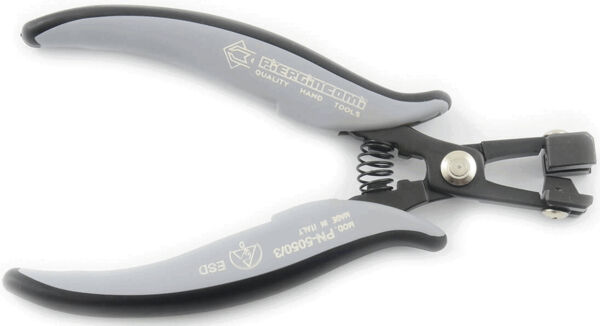 The image shows a stylus. It has two gray, ergonomic handles and a metallic, movable tip for cutting or shaping. The compression spring ensures easy opening and closing.