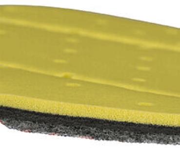 The image shows a multi-layered sponge. The top layer is yellow and soft, followed by a gray and then a black layer beneath it. The surface has small holes.