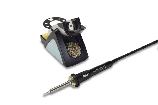 The image shows a soldering iron with a long cable and a soldering iron stand. The stand has a round holder and includes a metallic cleaning wire for the tip.