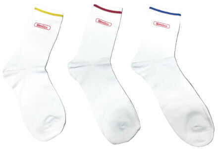 The image shows three white socks, each with colorful cuffs: one with a yellow, one with a red, and one with a blue cuff. All are slightly tilted.