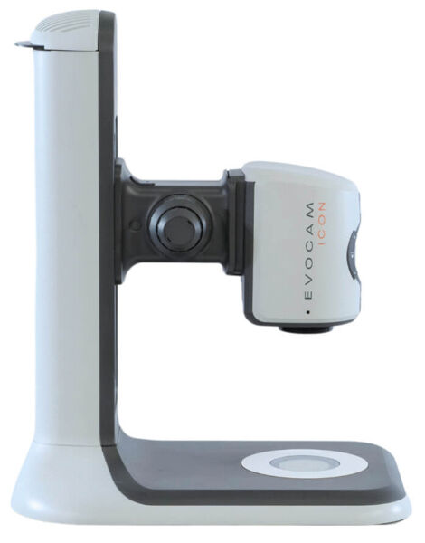 The image shows a device that looks like a tripod. It has a white and gray color with a camera mounted on the side. The base is wide and stable, ideal for a solid setup.