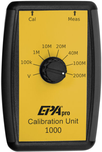 The image shows a yellow calibration device with a black casing. In the center, there is a large dial with various numerical markings (1M to 200M) and two arrows at the top for calibration and measurement.