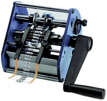 The image shows a manual resistance winding machine. It has a blue body, two rollers, and a handle. Resistors are arranged in a row and are wound automatically.