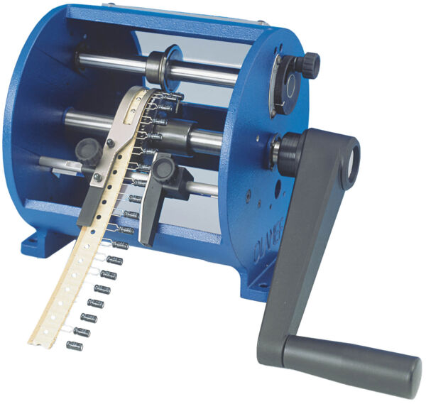 The image shows a blue, cylindrical machine with a crank. It has rollers inside and an elongated, perforated strip that is fed through the machine.