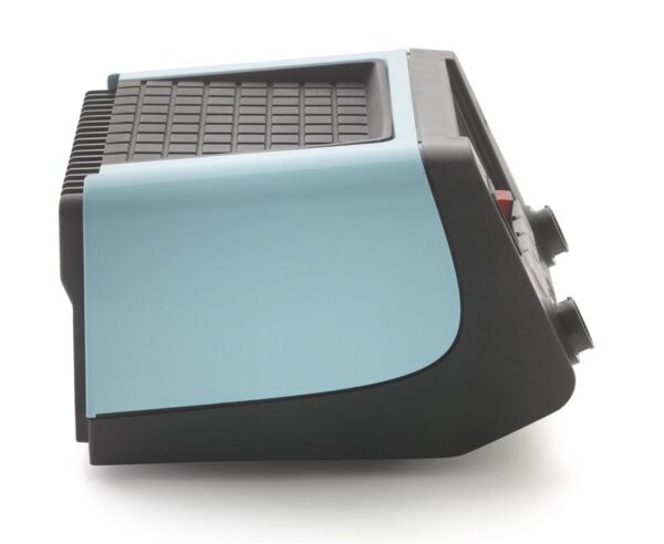 The image shows a compact, trapezoidal object in light blue and black. The top has a ridged design, while there are two knobs visible on the side.