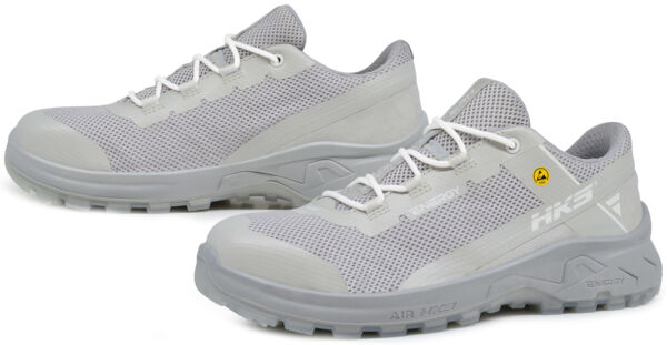 The image shows a pair of gray athletic shoes with a breathable mesh upper and a sturdy, rubberized sole. They have white laces and a modern, sporty shape.