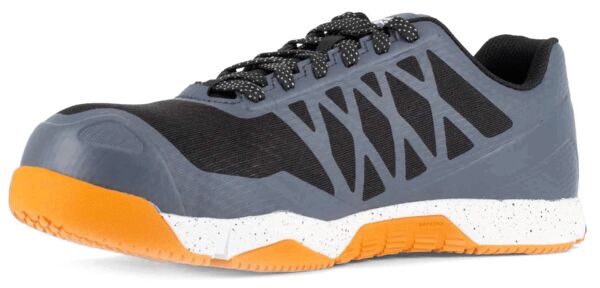 The shoe is sporty with a gray upper and black inserts. The sole is orange and has a white base with black dots. It has laces and a reinforced toe cap.