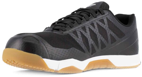 The image shows a black athletic shoe with a sturdy, round toe cap. The sole is made of non-slip material and features brown rubber areas. The shoe has a modern, sporty shape.